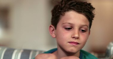 Geceleri kanepede düşünceli çocuk yüzü. Düşünceli çocuk.