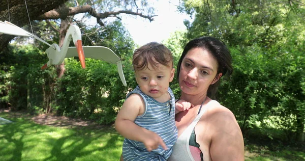 Mother Kissing Baby Backyard Toddler Boy Pointing Finger — Stockfoto