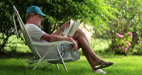 Person Reading Book Park Retired Man Enjoying Story — Stok fotoğraf