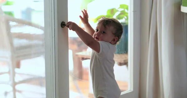 Adorable Baby Wanting Exit Hand Holding Window Knob — 스톡 사진