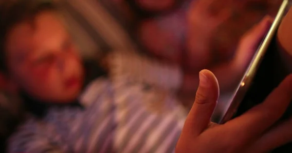 Stock image Boy holding tablet at night looking at screen