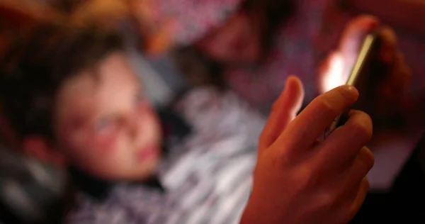 Stock image Closeup of child holding tablet tech device at night, kids watching movie