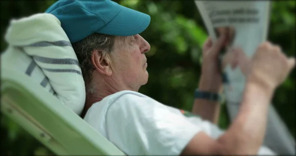 Candid Senior Man Reading News While Lying Relaxing Enjoying Retirement — Stockfoto