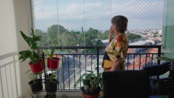 One Senior Lady Standing Apartment Balcony Looking Out Metropolitan City — Stock Video