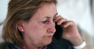 Senior older woman speaking on phone. Lady talking on cellphone