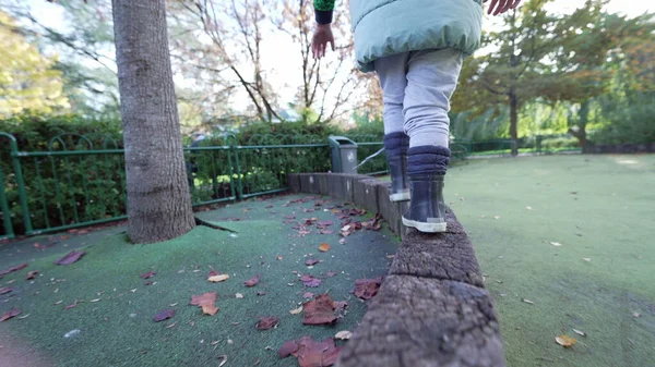 Child Closeup Feet Wearing Boots Training Balance Playground Wooden Surface — Stock Photo, Image