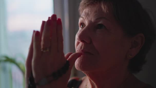 Θρησκευτική Ηλικιωμένη Γυναίκα Προσεύχεται Ροζάριο Στο Σπίτι Κλείνει Μάτια Περισυλλογή — Αρχείο Βίντεο