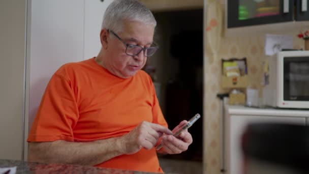 Senior Man Typing Message Phone While Sitting Kitchen Older Male — Stock Video
