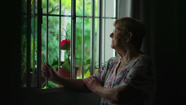 Elderly Woman Pensive Expression Holding Window Bar Contemplative Scene Authentic — Stock Photo, Image