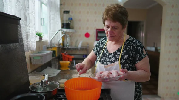 Senior Woman Cooking Authentic Domestic Lifestyle Scene Older Person Putting — Stock Photo, Image