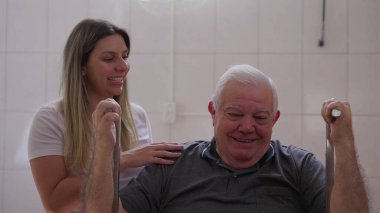 Pilates kadın eğitmeni tarafından çalıştırılan mutlu kıdemli bir adam.