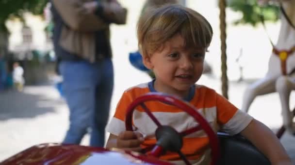 Cute Little Boy Having Fun City Funfair Holding Car Steering — Stock Video
