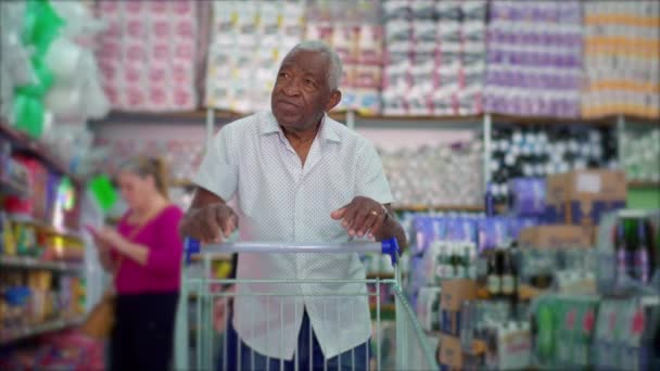 Een Senior Zwarte Shopper Duwen Winkelwagentje Supermarkt Browsen Producten Planken — Stockvideo