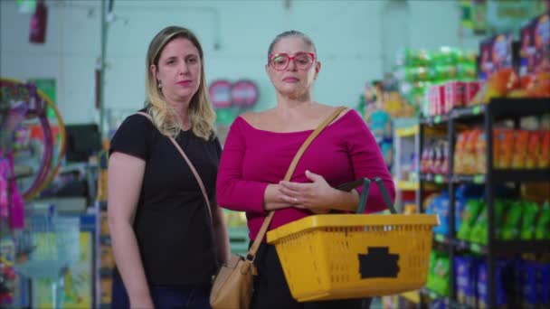 Portrait Two Serious Female Customers Standing Grocery Store Holding Basket — Stock Video