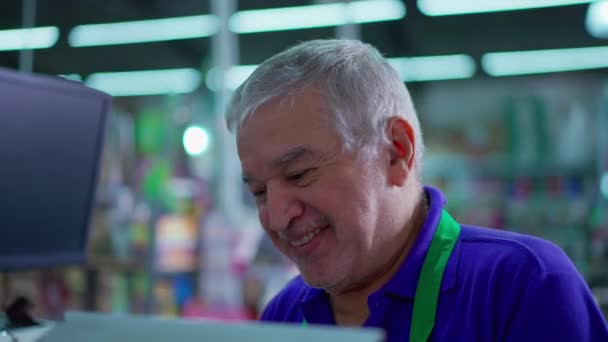 超级市场的高级职员与顾客在镜头外交流 与一位年长的杂货店收银员亲密接触 并面带微笑 — 图库视频影像