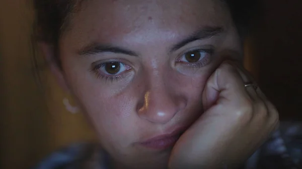 stock image Woman watching content online in front of blue screen late at night