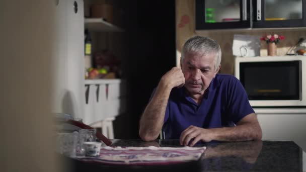 Melancholic Senior Man Sitting Home Alone Kitchen Table Ruminating Thoughts — Stock Video