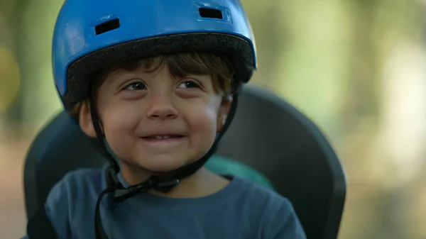 Child wearing bike helmet portrait kid sitting in bike back seat