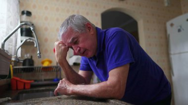 Bunalımlı son sınıf öğrencisi yalnızlık, endişe ve stres içinde. Evde yaşlı adam tarafından hissedildi. Mutfak lavabosuna yaslandı.