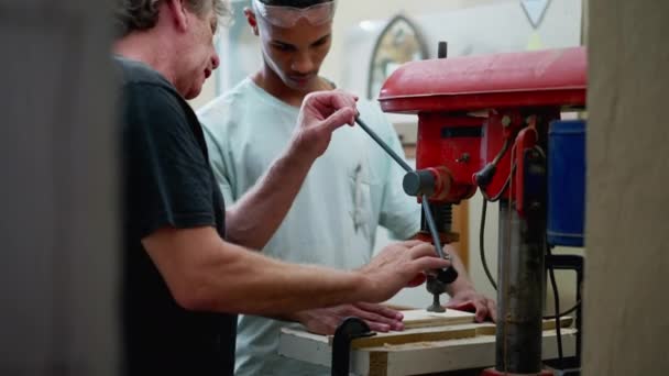 Senior Staff Guiding Carpentry Apprentice Use Machine Workshop Candid Scene — Stock Video