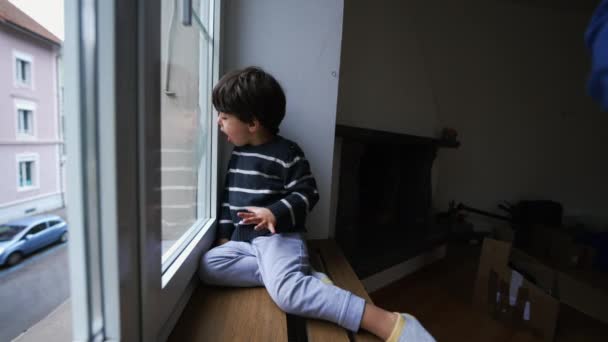 Child Daydream Sitting Window Apartment Breathing Glass Creating Vapor Bored — Stock Video