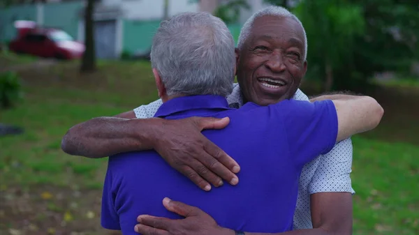 Two diverse Brazilian senior Friends Share Warm Embrace in Park. Old Age Friendship of elderly people Hugging, Displaying Camaraderie