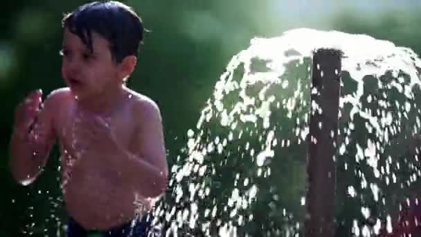 Kind Verfrissend Zich Bij Het Openbare Zwembad Water Fontein Slow — Stockvideo