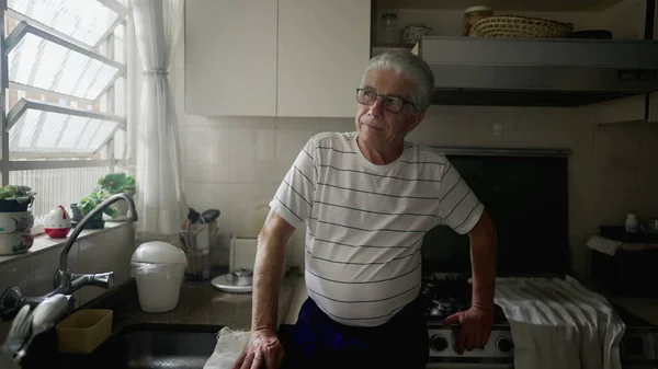 Відбиваючий Старший Чоловік Споглядає Спогади Про Життя Дивлячись Вікно Кухні — стокове фото
