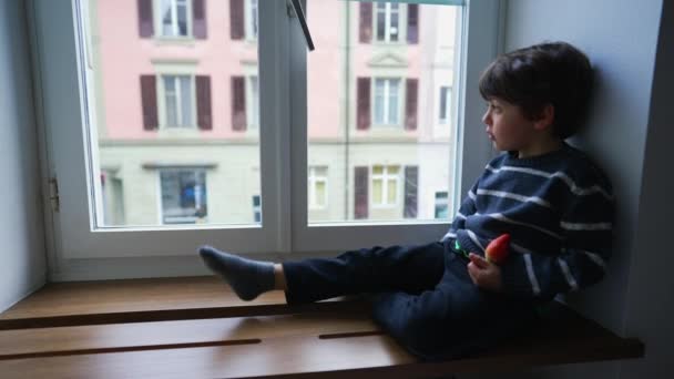 Pensive Little Boy Sitting Window Looking Out Window Staring Drizzle — Stock Video