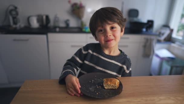Милый Маленький Мальчик Улыбается Камеру Стоя Кухне Перед Тарелкой Еды — стоковое видео