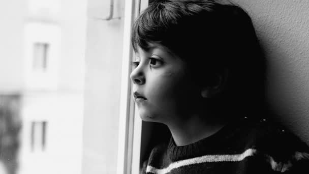 Child Contemplative Gaze Sitting Window Staring Street Residence Black White — Stock Video