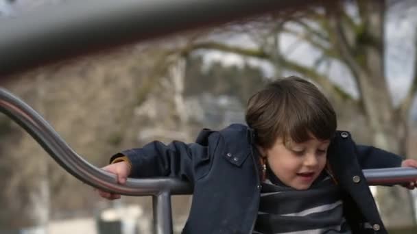 Upřímný Malý Chlapec Rotující Uvnitř Kruhového Objezdu Hřišti Během Podzimní — Stock video