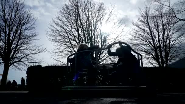Silhouette Children Spinning Playground Roundabout Carousel Winter Season — Stock Video
