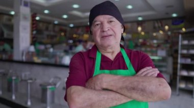 Önlükteki Kıdemli Restoran Personelinin Yakın Çekimi ve Kafeterya 'nın içinde çapraz kollar, Eski Yerel Gıda İşletme Müdürü