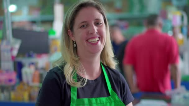 Joyful Female Supermarket Staff Smiling Camera Shoppers Background Checkout — Stock Video