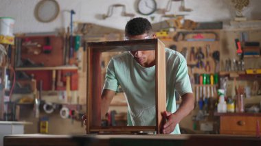 Genç Siyah Brezilyalı Marangoz Mobilya İnşaatı atölyesinde, sondaj ekipmanı kullanan çırak, marangozluk öğrencisi