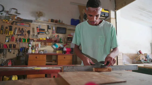 One Focused Black Brazilian Carpenter Sawing Wood Workshop Young Apprentice — Stock Photo, Image