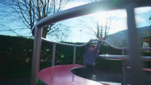 Kleiner Junge Wirbelt Fröhlich Auf Spielplatz Karussell Kind Genießt Drehung — Stockvideo