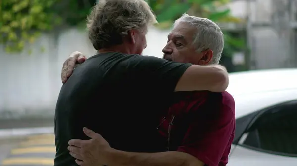 Authentic Loving Embrace Between Two Senior Friends Saying Farewell, Heart-warming Hug of Elderly People, Real Life Family Connection and Affection