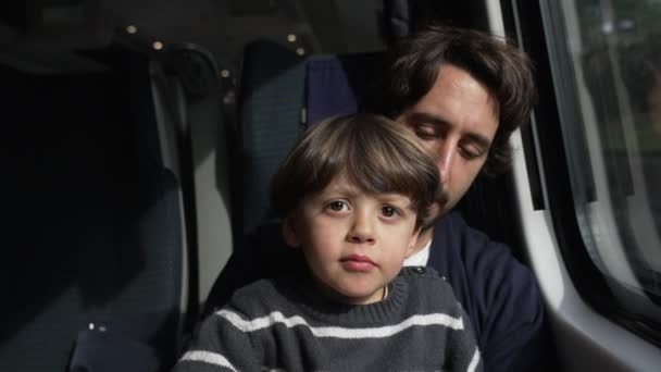 父亲和儿子一起乘火车旅行 乘客坐在高速车窗旁边 — 图库视频影像