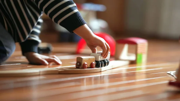 stock image Close-up of Kid's Hand with Retro Toy Railroad, Boy Playing with Vintage Train Set at Home