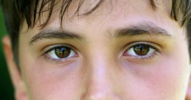 Kameraya bakan çocuk gözleri, kameraya bakan erkek gözlerinin makro yakın çekimi.