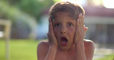 Child boy SHOCK reaction with despair. Emotional kid reacting with confusion