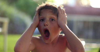 Child boy SHOCK reaction with despair. Emotional kid reacting with confusion