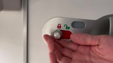  Opening airplane bathroom door lavatory. Passenger POV opens door