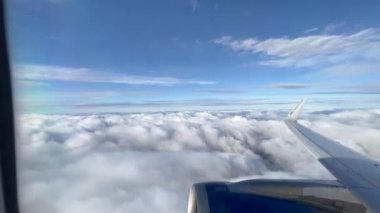  Traveling by plane POV perspective above cloud. beautiful landscape flight travel concept. Plane wing view
