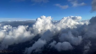 Clouds seen from plane window high above in the sky.