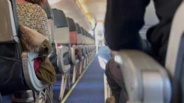 Airplane corridor aisle with passengers seated. Flight concept inside plane
