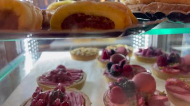 Sugar dessert treats on display at store behind glass