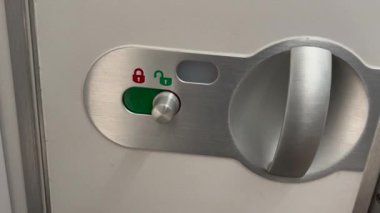 Opening and closing airplane bathroom door inside cabin